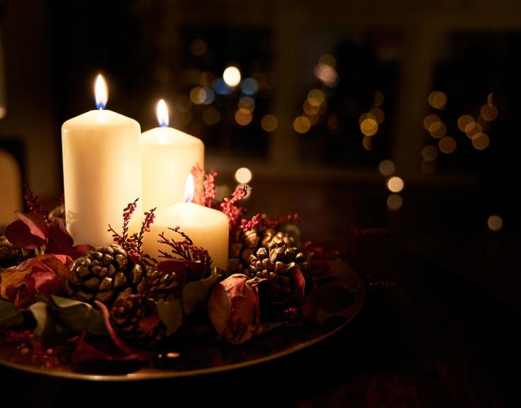 Candles surrounded by Christmas decorations